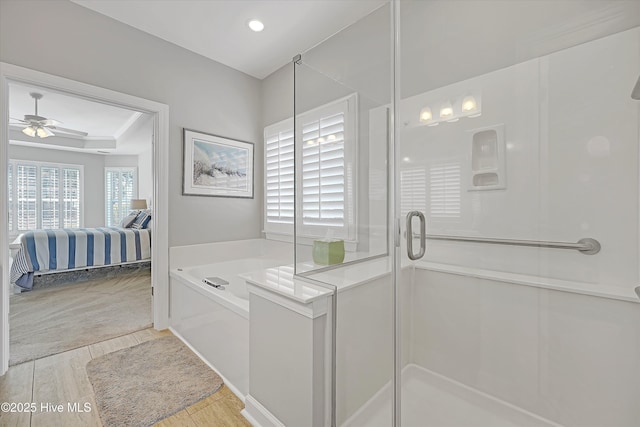 ensuite bathroom with a ceiling fan, ensuite bath, a garden tub, a shower stall, and recessed lighting