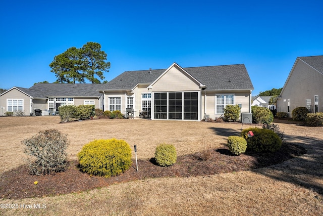 back of property with a sunroom