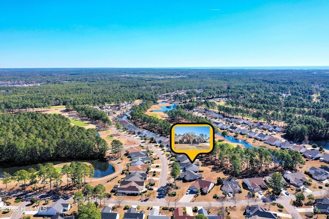 bird's eye view featuring a residential view and a wooded view