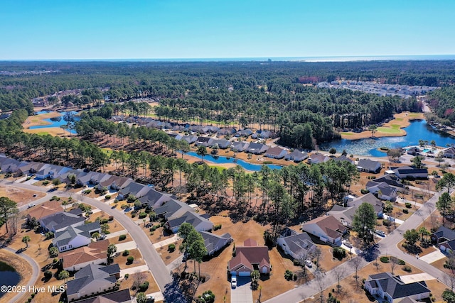 bird's eye view with a water view, a residential view, and a view of trees