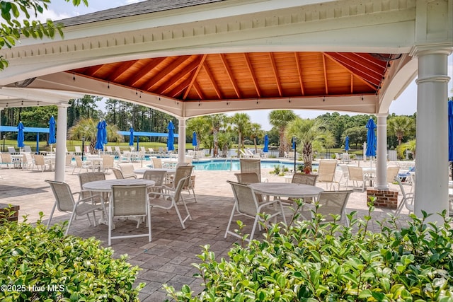 view of patio / terrace featuring a community pool and a gazebo