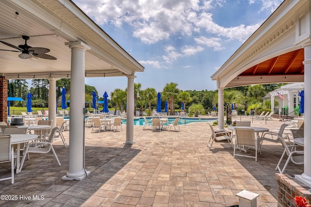 view of patio with ceiling fan, a community pool, and a gazebo