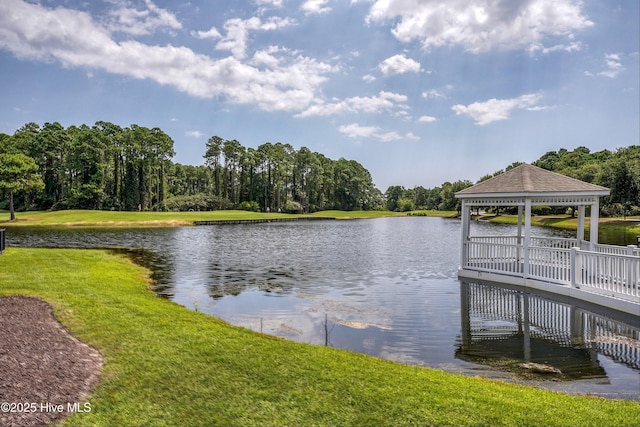 dock area with a water view, a lawn, and a gazebo