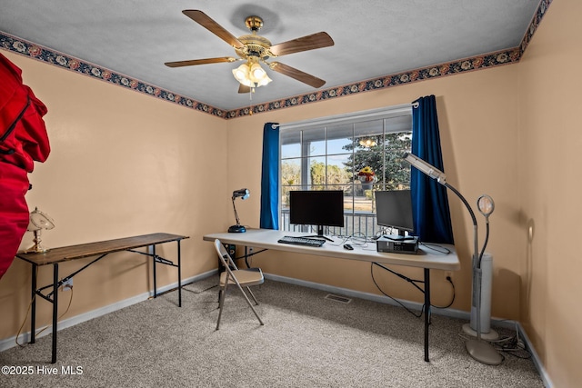 office area with carpet floors, a ceiling fan, and baseboards