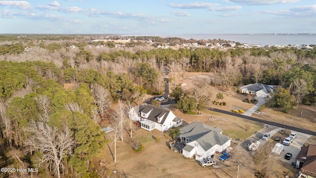 drone / aerial view with a water view and a wooded view