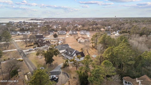 drone / aerial view with a water view and a residential view