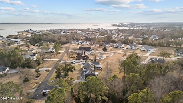 drone / aerial view with a residential view and a water view