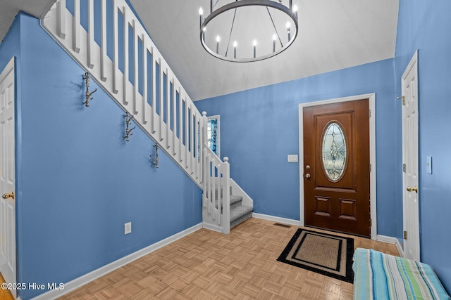 foyer featuring visible vents, stairway, baseboards, and an inviting chandelier