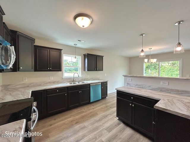 kitchen featuring dishwasher, light wood-style flooring, decorative light fixtures, stainless steel stove, and a sink