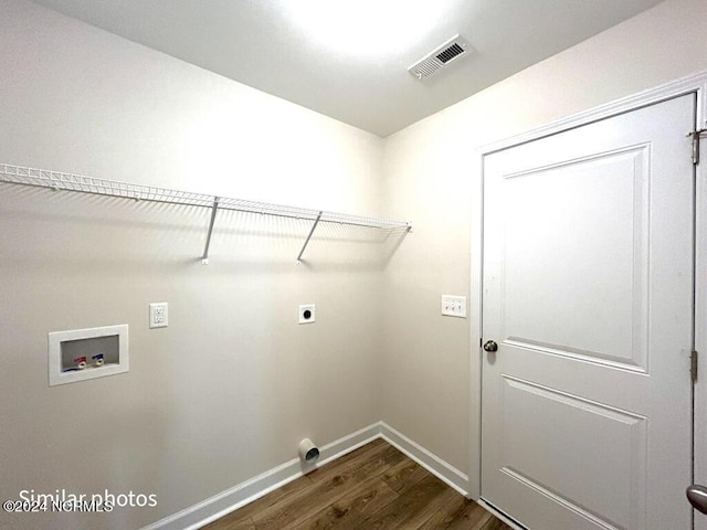 laundry area with laundry area, visible vents, dark wood finished floors, hookup for a washing machine, and electric dryer hookup