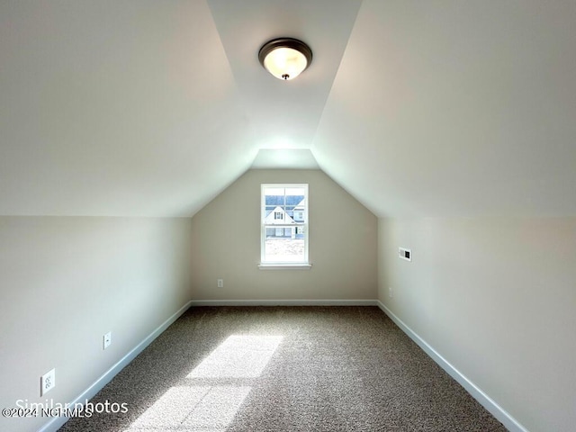 bonus room featuring carpet, vaulted ceiling, and baseboards