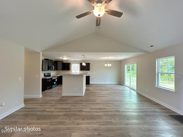 kitchen with wood finished floors, visible vents, open floor plan, light countertops, and stainless steel microwave