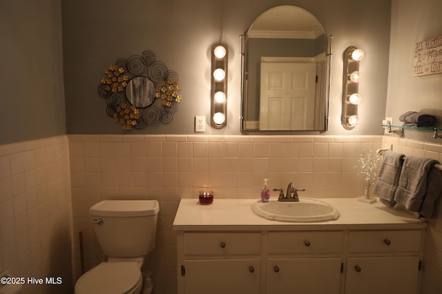 1426 Pocosin Rd, Winterville, NC 28590 - bathroom featuring tile walls, a wainscoted wall, toilet, and vanity
