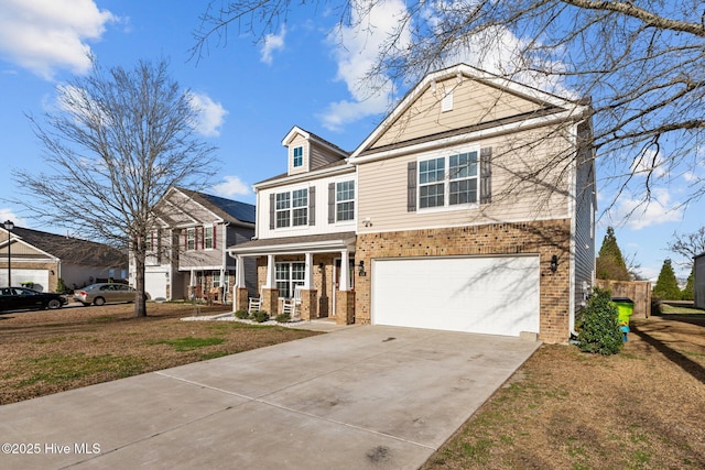 traditional home with brick siding, concrete driveway, covered porch, a garage, and a front lawn