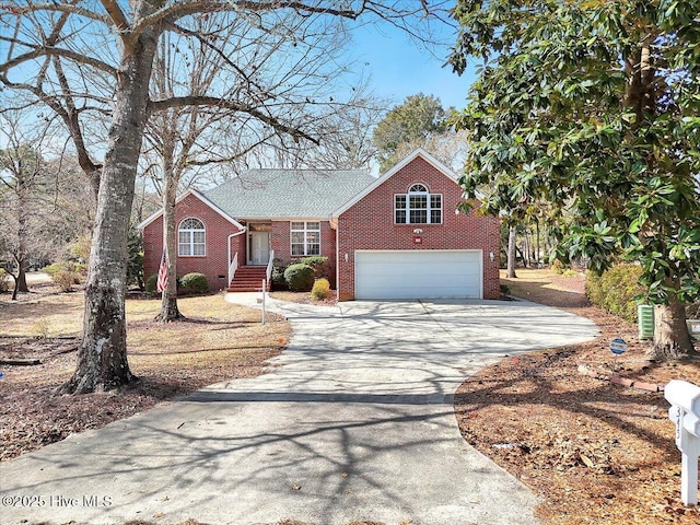 view of front facade with driveway, an attached garage, and brick siding