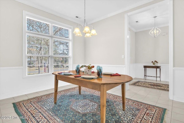 dining area featuring a chandelier, tile patterned floors, visible vents, and crown molding