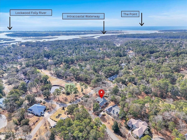 birds eye view of property with a view of trees