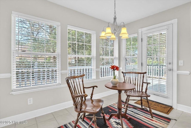 sunroom / solarium with an inviting chandelier