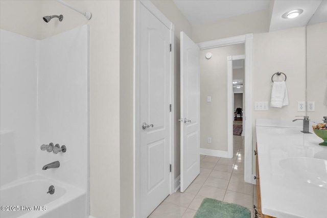 bathroom with shower / washtub combination, double vanity, a sink, baseboards, and tile patterned floors