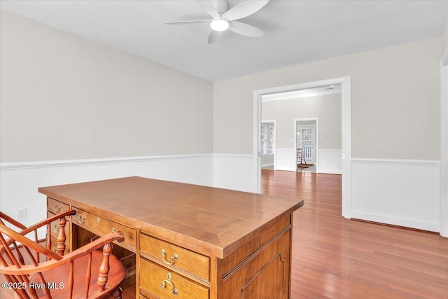 office with a ceiling fan and light wood finished floors