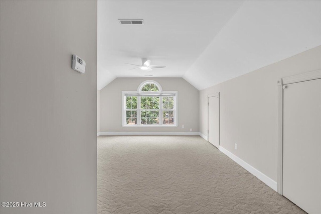 bonus room with lofted ceiling, visible vents, a ceiling fan, carpet flooring, and baseboards