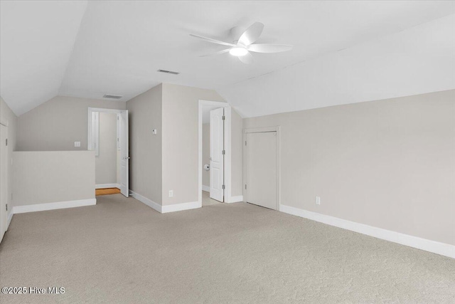 additional living space with ceiling fan, carpet, baseboards, and vaulted ceiling