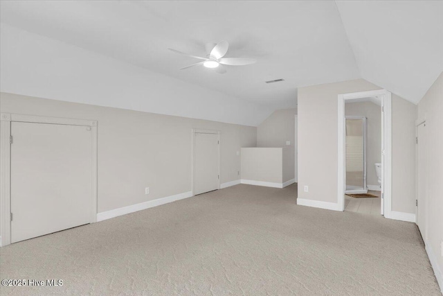 bonus room featuring carpet floors, visible vents, baseboards, vaulted ceiling, and a ceiling fan