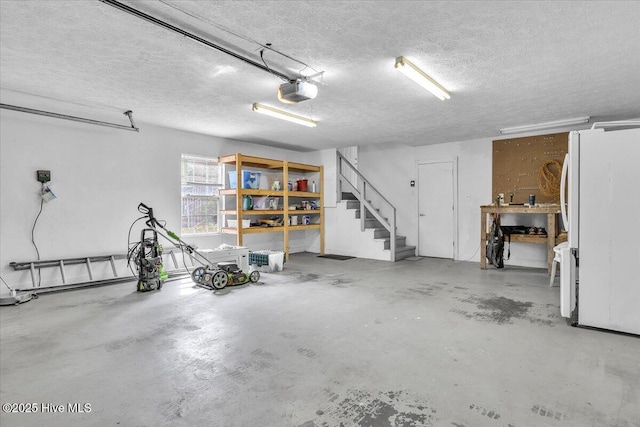 garage featuring freestanding refrigerator and a garage door opener