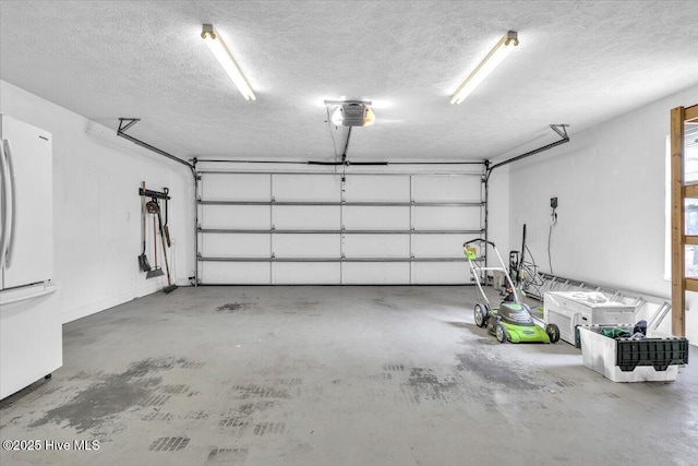 garage with a garage door opener and freestanding refrigerator