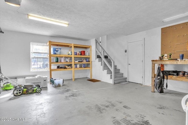 interior space featuring stairway, a textured ceiling, and a workshop area