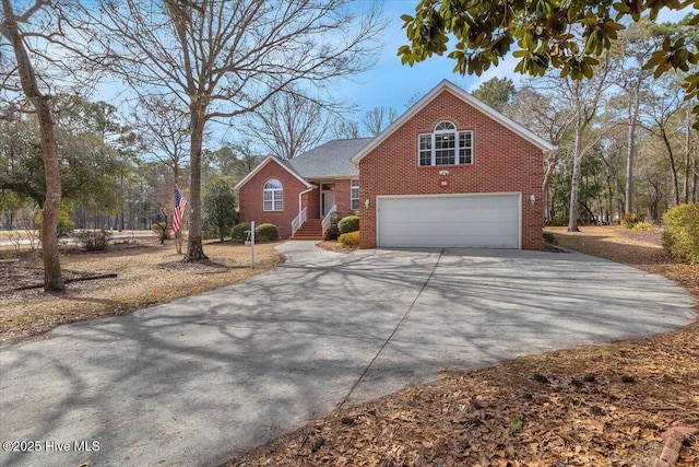 traditional-style home with driveway, brick siding, and an attached garage