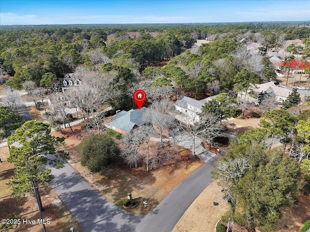 bird's eye view featuring a wooded view