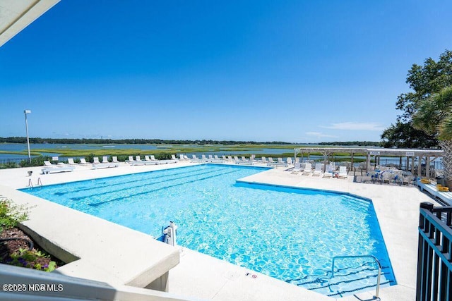 pool with a water view and a patio area