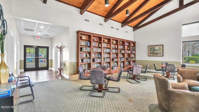 sitting room with high vaulted ceiling, carpet floors, visible vents, french doors, and beam ceiling