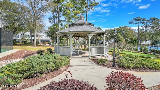 view of home's community with fence and a gazebo