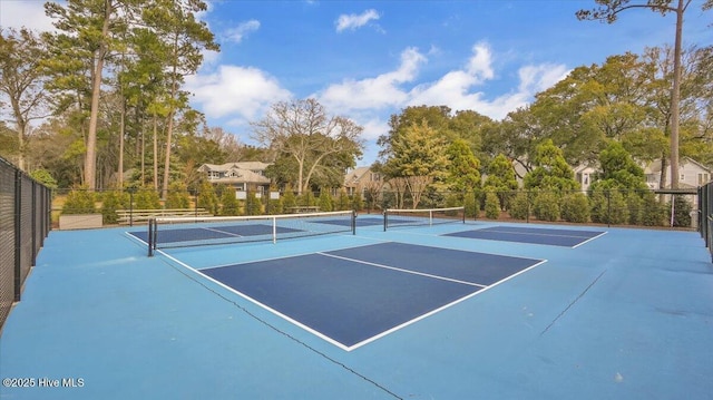 view of tennis court featuring fence