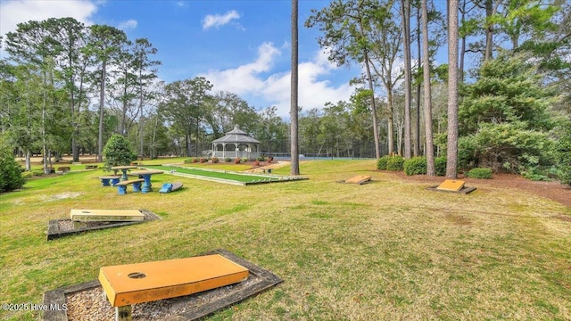 surrounding community with a gazebo and a yard