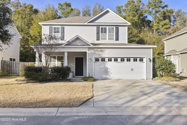 traditional home featuring a garage, concrete driveway, fence, and a porch