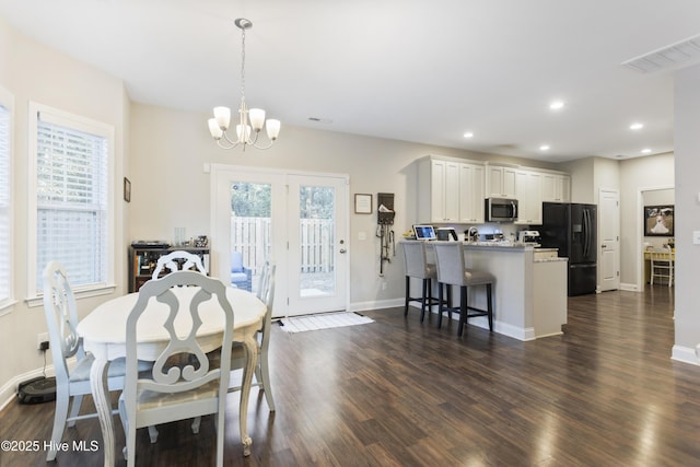 dining room with a chandelier, recessed lighting, dark wood-type flooring, visible vents, and baseboards