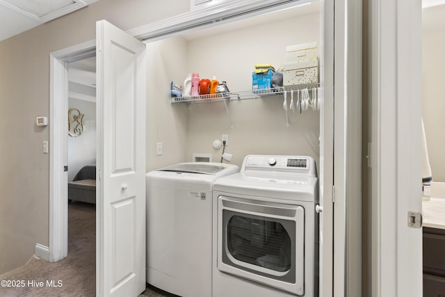 laundry room with laundry area, independent washer and dryer, and carpet flooring