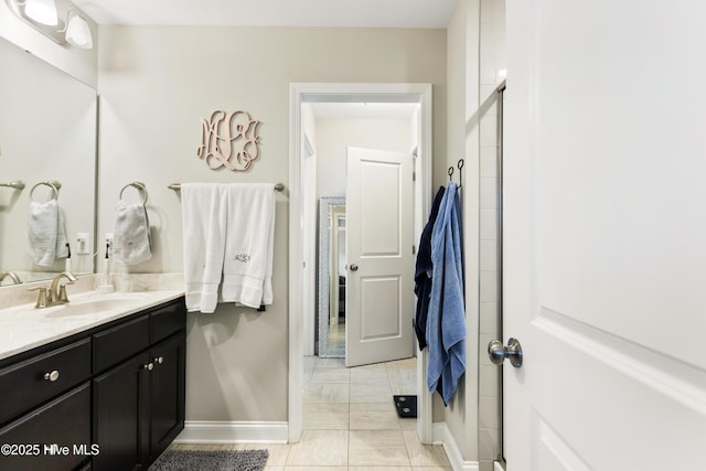 bathroom with tile patterned flooring, vanity, and baseboards