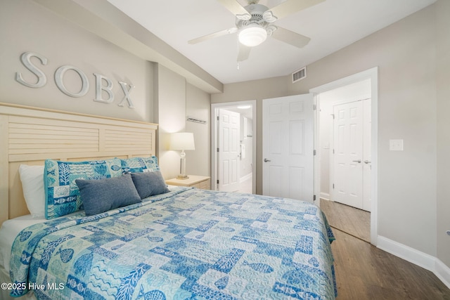 bedroom with a ceiling fan, wood finished floors, visible vents, and baseboards