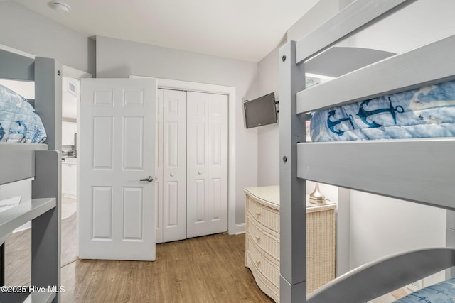 bedroom with a closet and wood finished floors