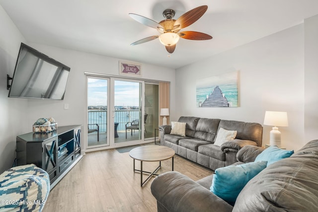 living room with light wood finished floors and a ceiling fan