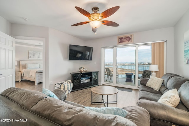 living area featuring ceiling fan and wood finished floors