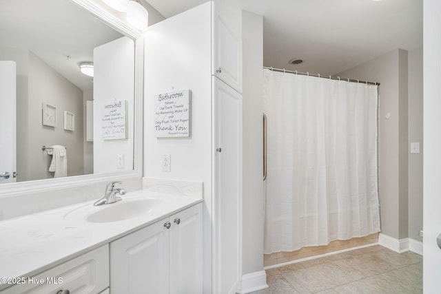 full bathroom with baseboards, tile patterned flooring, vanity, and a shower with curtain