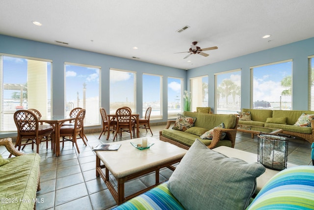 living area featuring recessed lighting, visible vents, and a healthy amount of sunlight