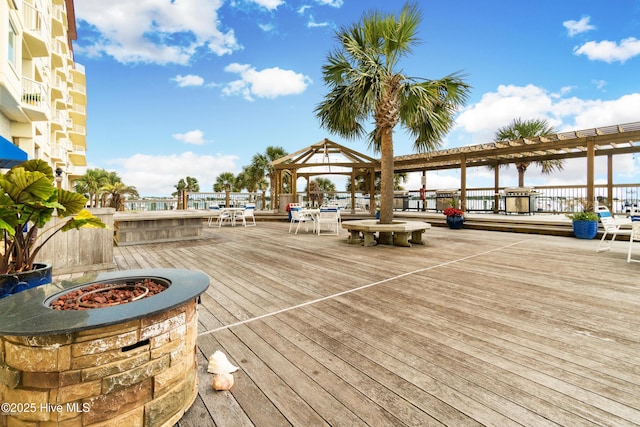 wooden terrace featuring a gazebo