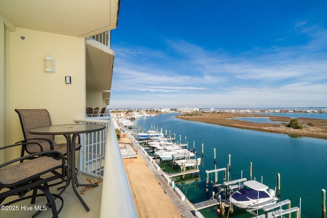 balcony with a dock and a water view