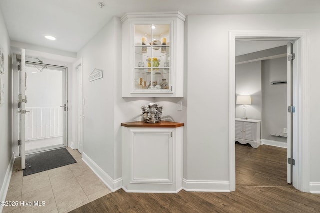 hall with recessed lighting, baseboards, and wood finished floors